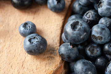 Blueberry berries. Fresh blueberries on a wooden table close-up. Sprinkle blueberries. Scattered fresh blueberries. Organic food on a wooden table. Selective focus