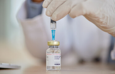 Smallpox vaccine, vial and hands of doctor for safety, healthcare or medicine in hospital. Closeup, nurse and prepare vaccination, virus injection and bottle for immunity, medical development or help