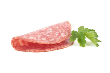 One sliced of delicious smoked sausage and parsley leaves on a white background.