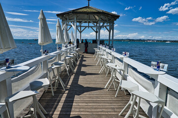 pier on Lake Constance in Bregenz (Austria) transformed into a bar on a summer day with blue skies...