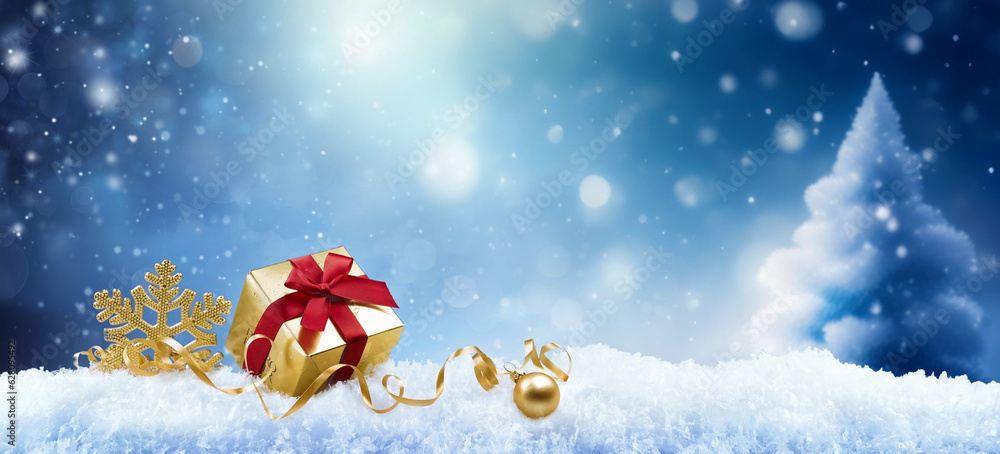 Poster christmas background with a golden gift, a snowflake and a ball in the snow in forest against a blue
