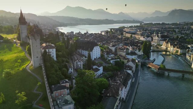 Aerial morning view of Lucerne old town and Reuss river. View of the watchtowers and city wall in Luzern, Switzerland. Swiss Alps on background
