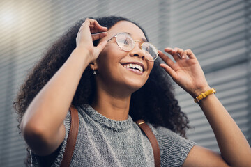 .Woman, smile and city travel of student with glasses on a street with vision of future dream. Urban, university holiday and happy young African person walking with backpack on adventure or vacation.