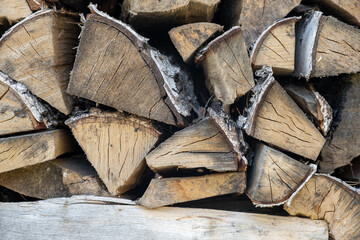 firewood background of chopped wood for kindling and heating the house Close-up. a woodpile with...