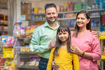 Happy Indian family at grocery shop.