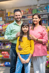 Happy Indian family at grocery shop.