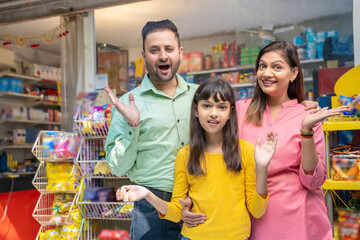 Happy Indian family at grocery shop.