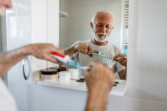 Cleaning, mouth or hand brushing teeth with dental toothpaste for healthy oral hygiene grooming. Eco friendly, senior man with a natural toothbrush for teeth whitening.