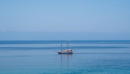 Obraz premium Picturesque scenery of Albanian Ionian Sea coast with tourist excursion yacht boats at Saranda city. excursion boat