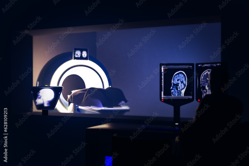 Poster in control room radiologist diagnosis while watching procedure and monitors showing brain scans resu