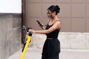 young black woman taking a scooter for a rent in the city, eco friendly vehicle