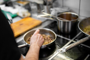 Chef cook hand cooking food at the restaurant kitchen