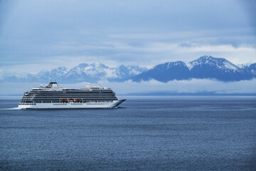 Breathtaking mountain glacier range view with luxury cruiseship cruise ship liner Orion sailing in...