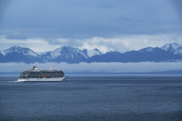 Breathtaking mountain glacier range view with luxury cruiseship cruise ship liner Orion sailing in...
