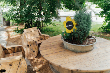 Cute wooden picnic table in a public park. Pic-nic time.