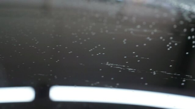 Hydrophobe on the car body. Car body coated with ceramic compound repels water. Car detailing video.