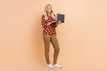 Full length photo of gorgeous representative lady hold wireless netbook networking isolated on...