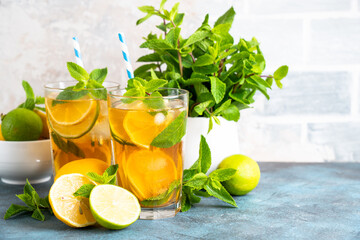 Iced tea with lemon, lime, mint and ice.