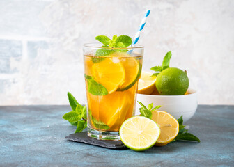 Iced tea with lemon, lime, mint and ice.