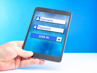 Website login form. Electronic tablet in hand. Place to enter username and password. Internet...