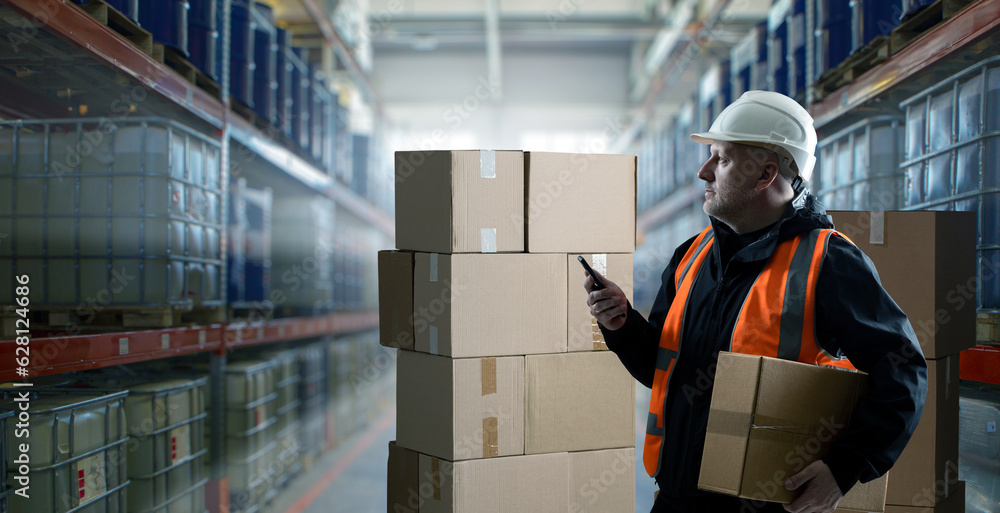 Poster man in warehouse. loader with phone and box. company storehouse contractor. man in uniform and loade