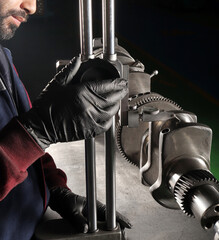 Master makes metal hardness measurement. Crankshaft.