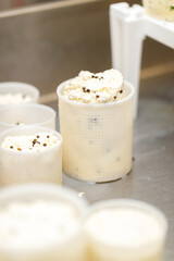 Close shot for proces of making and shaping soft, white cheese, no face