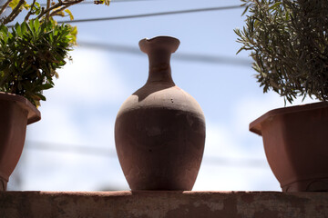 Fototapeta na wymiar Clay Pot On A Balcony - Antique Terracotta Amphora 