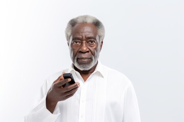 Portrait of an elderly man with glasses holding out a phone, on a white background. copy space