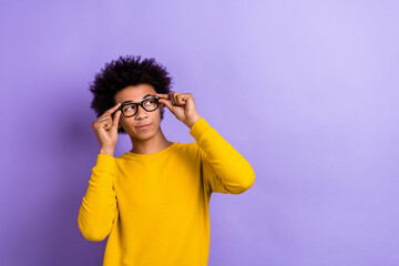 Photo of intelligent positive clever guy dressed yellow long sleeve touching glasses look empty...