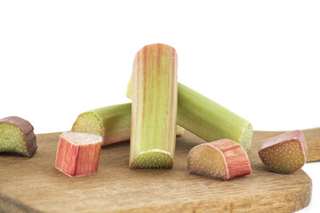 Rhubarb stalks of varying colors over white background