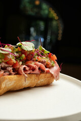 Bruschetta toast with bacon slices and fresh vegetables