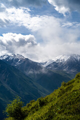 Fototapeta premium cloudy weather in a mountain gorge. clouds over mountain peaks