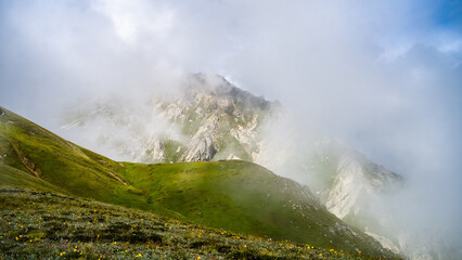 mountains in the fog. cloudy weather in a mountain gorge. clouds over mountain peaks