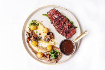 Beef steak with mushrooms and potatoes with demi-glace sauce