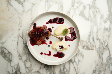 Baked duck leg with mashed potatoes and berry sauce