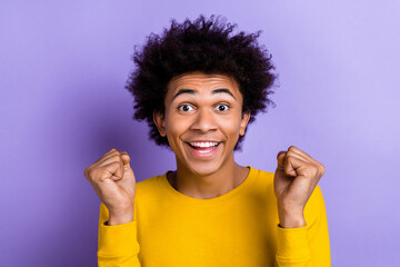 Closeup photo of youngster guy raise fists up celebrate his exam passed hooray summer holidays begin isolated on violet color background