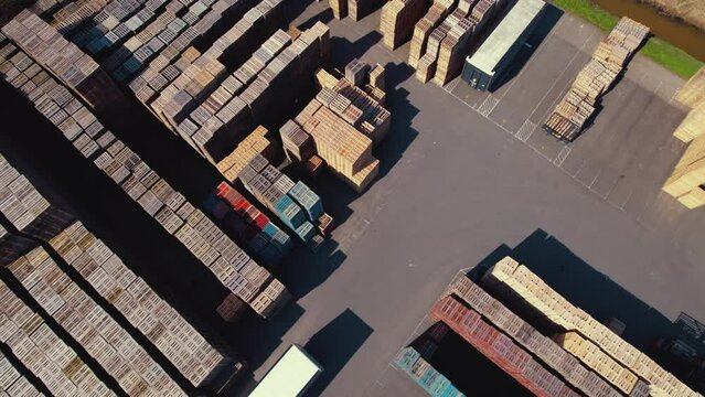 Aerial video shot of a square with many wooden pallets stacked one on another. High quality 4k footage