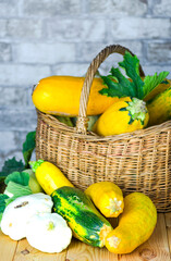 fresh zucchini and squash in a wicker basket