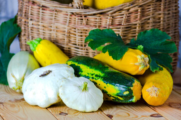 fresh zucchini and squash in a wicker basket