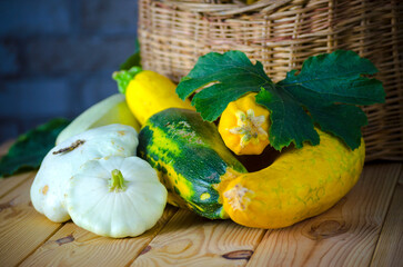 fresh zucchini and squash in a wicker basket