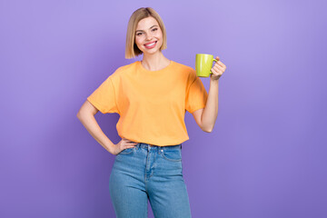 Portrait of cute adorable girl with bob hairdo dressed stylish clothes hold cup of tea hand on waist isolated on violet color background