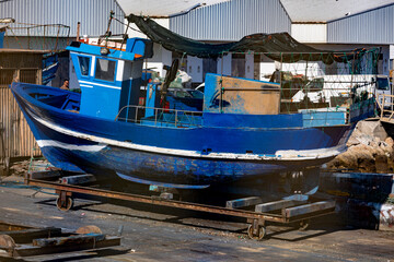 Fototapeta na wymiar Blue fishing boat in the docks