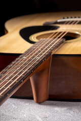 Fototapeta premium Classical guitar close up. Acoustic guitar on wood background.Music instrument concept