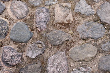 fragment of a road made of stone. Backgrounds and texture