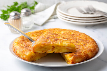 Spanish omelette with potatoes, typical spanish cuisine on gray concrete floor. Tortilla Espanola. Turkish name; Yumurtali patates