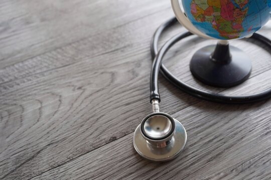 Selective focus image of stethoscope and world globe with copy space. Global health and world health day concept