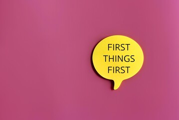 Top view image of speech bubble with text FIRST THINGS FIRST on pink background with copy space
