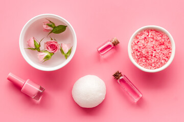 Pink roses cosmetic products set with flowers essential oil. Beauty care concept.