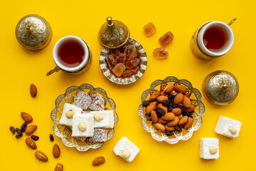 Muslim holiday with tea in traditional bronze cups with sweets